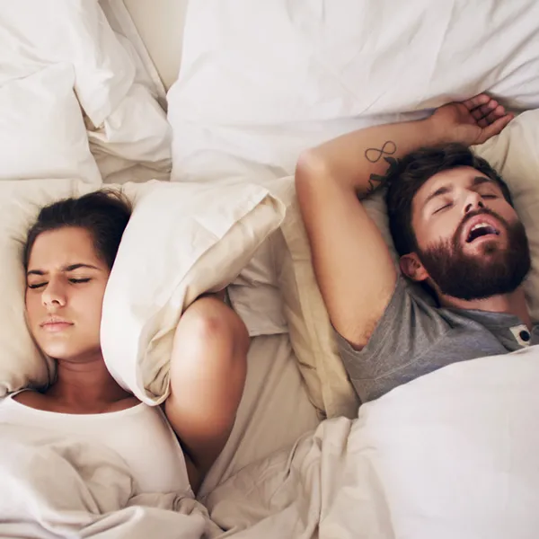 Man With Sleep Apnea Snoring Loudly In Bed